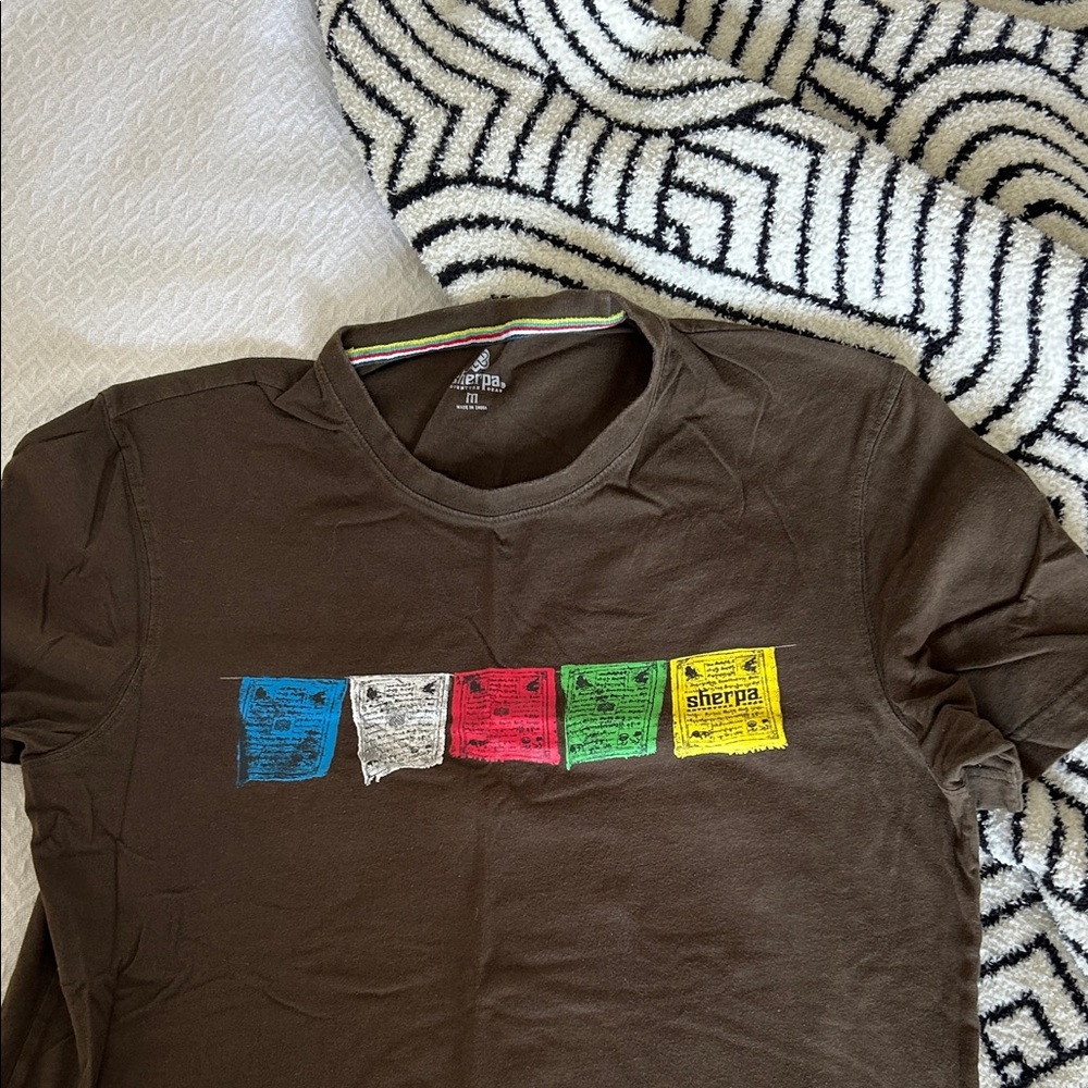 Sherpa Men's Brown Tee with Colorful Flag Design